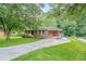 Single story brick home with driveway, covered parking, and spacious front lawn at 2194 Freydale Se Rd, Marietta, GA 30067