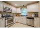 Functional kitchen with stainless steel appliances, white cabinetry, and ample counter space at 2194 Freydale Se Rd, Marietta, GA 30067
