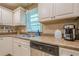 Traditional kitchen featuring white cabinets, stainless steel appliances, and a window providing natural light at 2194 Freydale Se Rd, Marietta, GA 30067