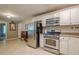 A compact kitchen with stainless steel appliances and white cabinets, providing a functional cooking space at 2194 Freydale Se Rd, Marietta, GA 30067