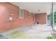 Covered outdoor patio with brick walls, concrete flooring, and view of backyard and utility shed at 2194 Freydale Se Rd, Marietta, GA 30067