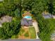 Aerial view of a single Gathering home with a kidney shaped pool surrounded by lush greenery at 3559 Turtle Cove Se Ct, Marietta, GA 30067