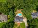 Aerial view of a single Gathering home with a kidney shaped pool surrounded by lush greenery at 3559 Turtle Cove Se Ct, Marietta, GA 30067