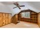 Cozy attic space featuring wood paneling, built-in shelves, and a window at 3559 Turtle Cove Se Ct, Marietta, GA 30067
