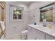 Bathroom featuring beadboard accent, stylish vanity with white countertop, toilet, and shower at 3559 Turtle Cove Se Ct, Marietta, GA 30067