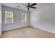 Bright bedroom with neutral carpet, ceiling fan, and dual windows allowing for lots of natural light at 3559 Turtle Cove Se Ct, Marietta, GA 30067