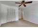 Bedroom with a ceiling fan, carpet, and closet space at 3559 Turtle Cove Se Ct, Marietta, GA 30067