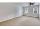 Bright bedroom features neutral carpet, ceiling fan, and natural light from two windows at 3559 Turtle Cove Se Ct, Marietta, GA 30067