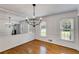Refined dining room with hardwood floors, decorative chandelier, and mirrored wall creates an elegant atmosphere at 3559 Turtle Cove Se Ct, Marietta, GA 30067
