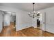 Elegant dining room with hardwood floors, classic chandelier, and access to kitchen, perfect for entertaining guests at 3559 Turtle Cove Se Ct, Marietta, GA 30067