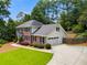 Charming two-story brick home with attached garage and well-manicured lawn surrounded by mature trees at 3559 Turtle Cove Se Ct, Marietta, GA 30067