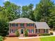 Charming brick home with a manicured lawn, mature trees, and classic shutters creates an inviting curb appeal at 3559 Turtle Cove Se Ct, Marietta, GA 30067