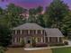 Beautiful brick home featuring a classic design, black shutters, and professional landscaping at 3559 Turtle Cove Se Ct, Marietta, GA 30067
