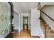 Inviting foyer features hardwood floors, staircase, and a decorative glass front door, enhancing the home's elegance at 3559 Turtle Cove Se Ct, Marietta, GA 30067