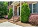 Close up of a brick front porch with manicured bushes, steps with metal railing, and an inviting entry way at 3559 Turtle Cove Se Ct, Marietta, GA 30067