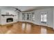 Bright living room features hardwood floors, brick fireplace, and large windows at 3559 Turtle Cove Se Ct, Marietta, GA 30067