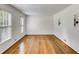 Spacious living room with beautiful hardwood floors, white walls, crown molding, and natural light from large windows at 3559 Turtle Cove Se Ct, Marietta, GA 30067