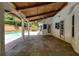 Covered patio with wood ceiling and stone flooring overlooks the pool and backyard at 3559 Turtle Cove Se Ct, Marietta, GA 30067