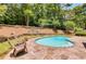 Pool featuring stone-paved patio, lush green landscaping, and lounge chairs at 3559 Turtle Cove Se Ct, Marietta, GA 30067