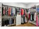 A large walk-in closet with custom shelving and hanging rods for clothes and accessories at 2020 Bixby Se St, Atlanta, GA 30317