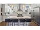 Open kitchen with granite countertops, stainless steel appliances, white cabinets, and island seating at 2020 Bixby Se St, Atlanta, GA 30317