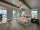 Bright main bedroom with wood floors, multiple windows, ceiling fan, bench and a large bed at 962 Bibbs Nw Cir # 8, Atlanta, GA 30318