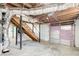 Spacious unfinished basement with staircase and access to the garage at 1834 Buckeye Sw St, Atlanta, GA 30310