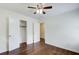 Bedroom featuring a closet, hardwood floors, ceiling fan, and access to additional rooms at 1834 Buckeye Sw St, Atlanta, GA 30310