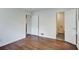 Bedroom with hardwood floors and doors to the bathroom at 1834 Buckeye Sw St, Atlanta, GA 30310