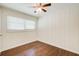 Cozy bedroom with a ceiling fan, natural light, and well-maintained hardwood floors at 1834 Buckeye Sw St, Atlanta, GA 30310