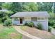 Charming single story home with brick exterior and landscaped front yard nestled among mature trees at 1834 Buckeye Sw St, Atlanta, GA 30310