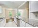 Bright kitchen with granite countertops, stainless steel dishwasher, white cabinets, and open floor plan at 1834 Buckeye Sw St, Atlanta, GA 30310
