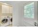 Laundry room featuring full sized washer and dryer and door to exterior at 1834 Buckeye Sw St, Atlanta, GA 30310