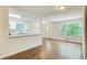 Bright living room featuring hardwood floors, white trim, and an adjacent pass-through kitchen at 1834 Buckeye Sw St, Atlanta, GA 30310