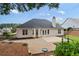 Backyard view of the home showing a large stone patio and fenced yard, offering privacy and space for outdoor enjoyment at 3549 Daventry Nw Ln, Kennesaw, GA 30144