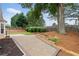 Spacious backyard featuring a large brick patio, lush green lawn, and mature trees, perfect for outdoor entertaining at 3549 Daventry Nw Ln, Kennesaw, GA 30144