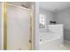Bathroom featuring a glass enclosed shower and a large white soaking tub at 3549 Daventry Nw Ln, Kennesaw, GA 30144