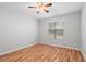 Bedroom with hardwood floors, ceiling fan, and a window overlooking the yard at 3549 Daventry Nw Ln, Kennesaw, GA 30144