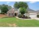 Welcoming curb appeal with manicured lawn, brick and siding facade, and an attached garage, creating an inviting home exterior at 3549 Daventry Nw Ln, Kennesaw, GA 30144