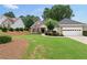 Attractive home with a combination brick and siding front, lush landscaping, and an attached two-car garage offering curb appeal at 3549 Daventry Nw Ln, Kennesaw, GA 30144