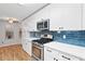 Bright kitchen showcasing white cabinets, stainless steel appliances, and a modern backsplash at 3549 Daventry Nw Ln, Kennesaw, GA 30144
