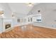 Spacious living room with vaulted ceilings, fireplace, hardwood floors, and open concept to kitchen at 3549 Daventry Nw Ln, Kennesaw, GA 30144