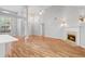 Open concept living room with vaulted ceilings, fireplace, modern lighting, and hardwood floors at 3549 Daventry Nw Ln, Kennesaw, GA 30144