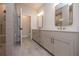 Modern bathroom with a double vanity, framed mirrors, and tile flooring at 606 Goldsmith Ct # 114, Johns Creek, GA 30022