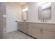 Bathroom featuring a double vanity with framed mirrors and tile flooring at 606 Goldsmith Ct # 114, Johns Creek, GA 30022