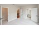 Bright, spacious bedroom with three open doorways and neutral carpeting at 606 Goldsmith Ct # 114, Johns Creek, GA 30022