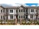 Attractive brick townhome with black iron fence and stone gate posts at 606 Goldsmith Ct # 114, Johns Creek, GA 30022