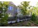 Brick townhomes with tidy landscaping and black iron fencing at 606 Goldsmith Ct # 114, Johns Creek, GA 30022