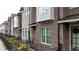 Brick townhouses feature black iron fences and private landscaped yards at 606 Goldsmith Ct # 114, Johns Creek, GA 30022