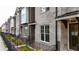 Brick townhouses feature black iron fences and front yard landscaping at 606 Goldsmith Ct # 114, Johns Creek, GA 30022